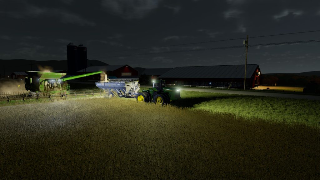 Screenshot from FS22 showing harvesting with John Deere equipment